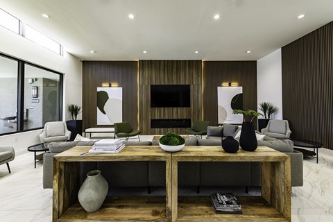A modern living room with a wooden coffee table and grey couches.