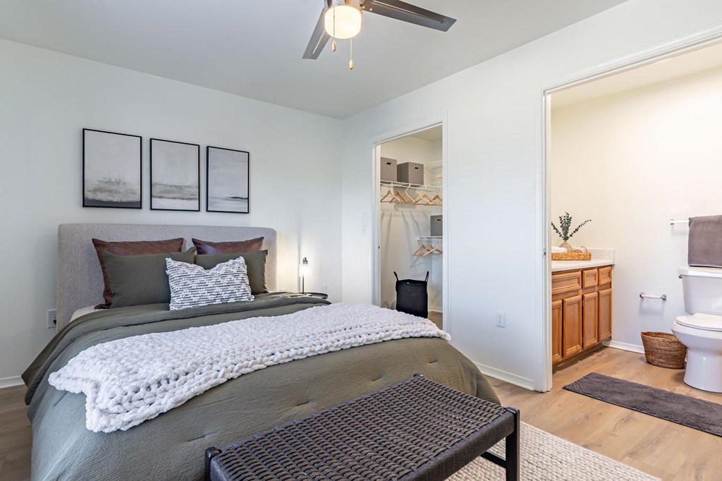 a bedroom with a bed and a bathroom with a toilet