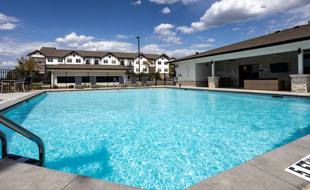 a swimming pool with a building in the background
