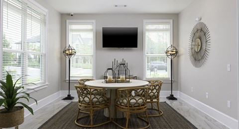 A dining room with a round table and chairs.