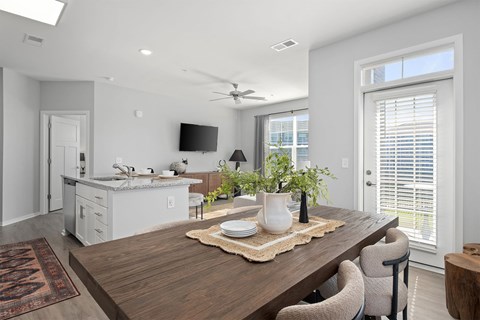 A modern dining room with a wooden table and chairs.