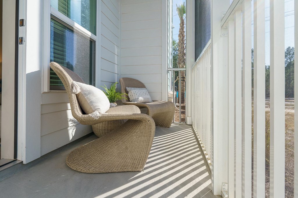 A patio with a chair and a table.
