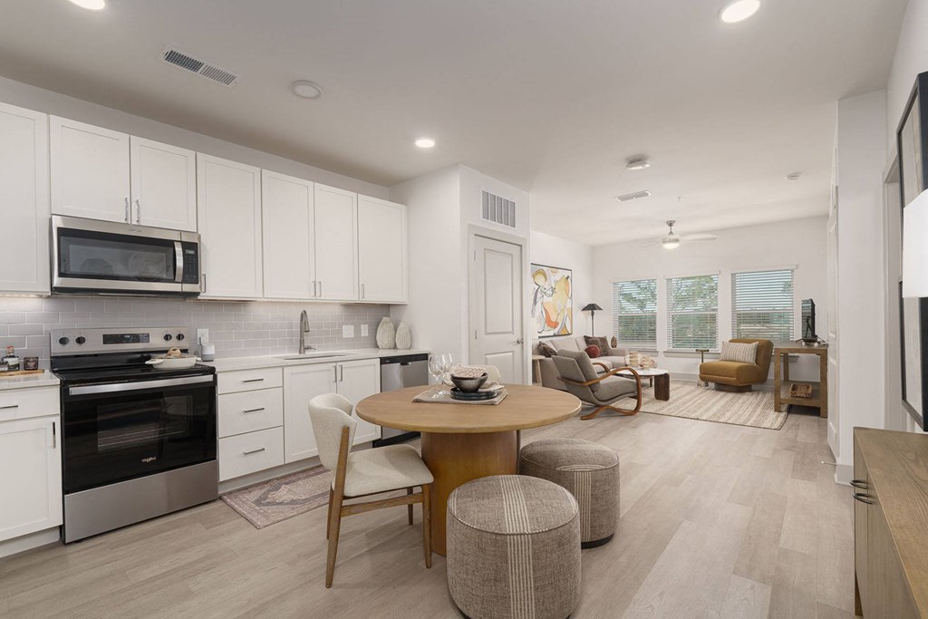 A modern kitchen with a dining table and chairs.
