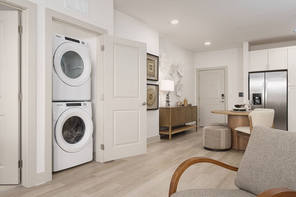 A modern laundry room with a washer and dryer in the doorway.
