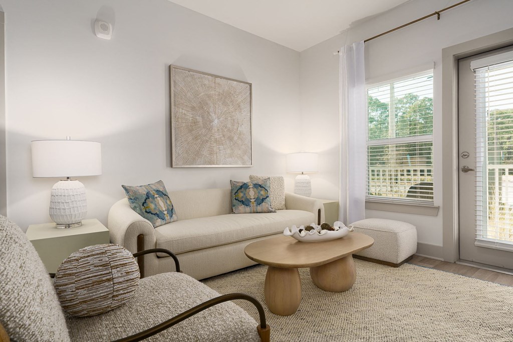 A living room with a couch, armchair, and coffee table.