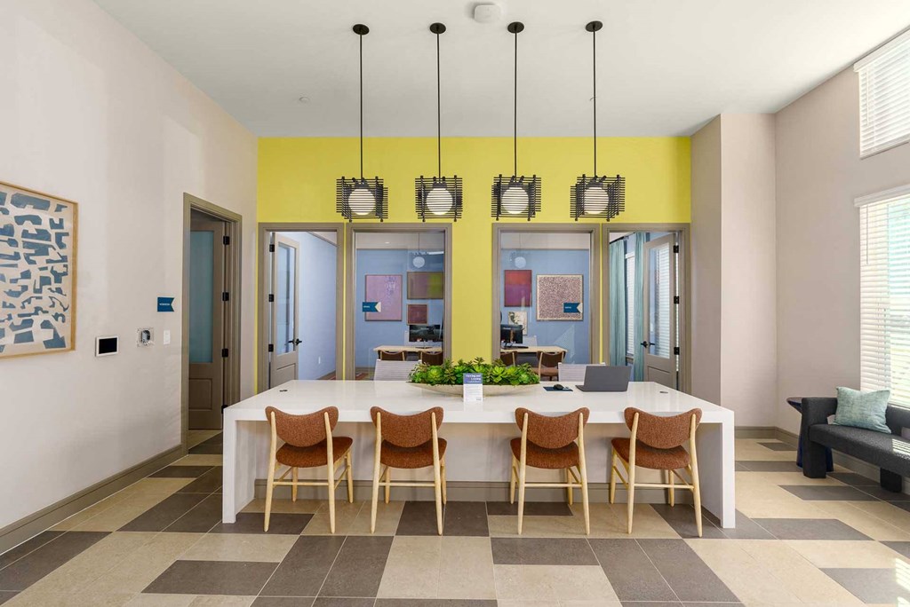 A dining room with a table and chairs.