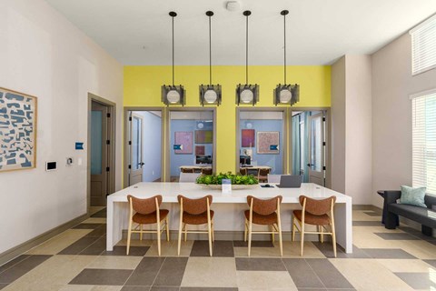 A dining room with a table and chairs.