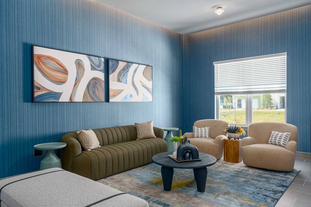 A living room with a brown sofa, two armchairs, and a coffee table.