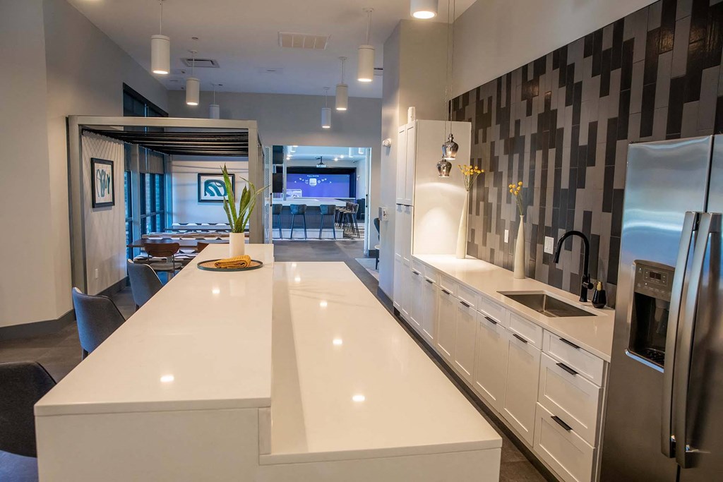 a kitchen with white cabinets and a white counter top