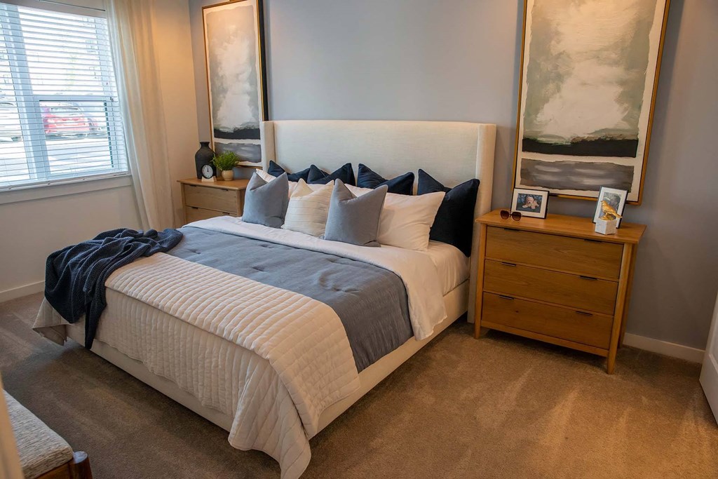 a bedroom with a bed and two night stands