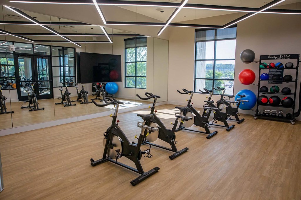 a room filled with lots of different types of exercise bikes