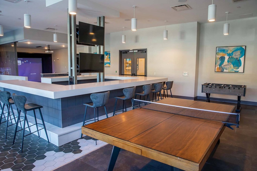 a game room with a foosball table and a bar