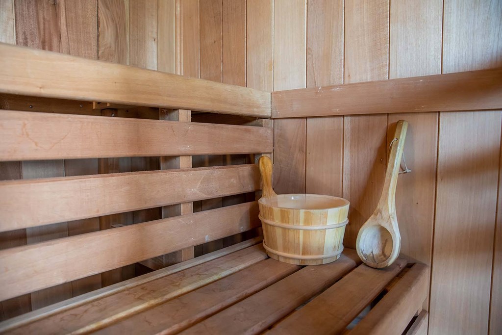 a wooden sauna with a wooden bucket and wooden spoons