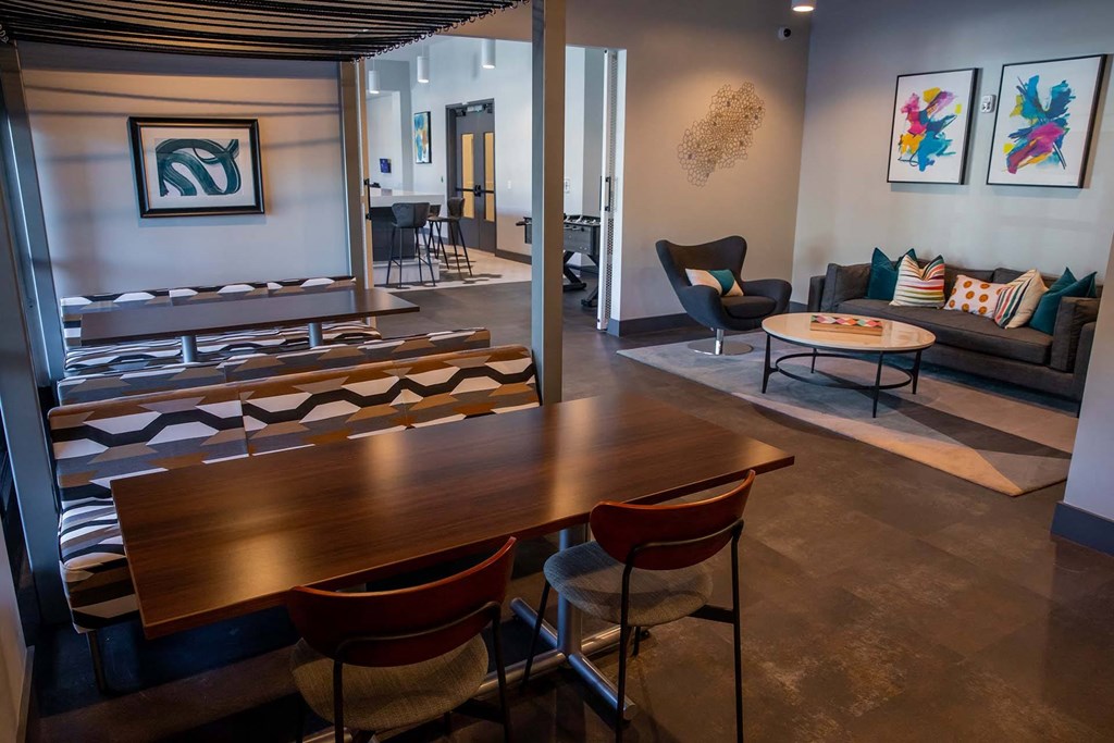 clubhouse room filled with furniture and a large window