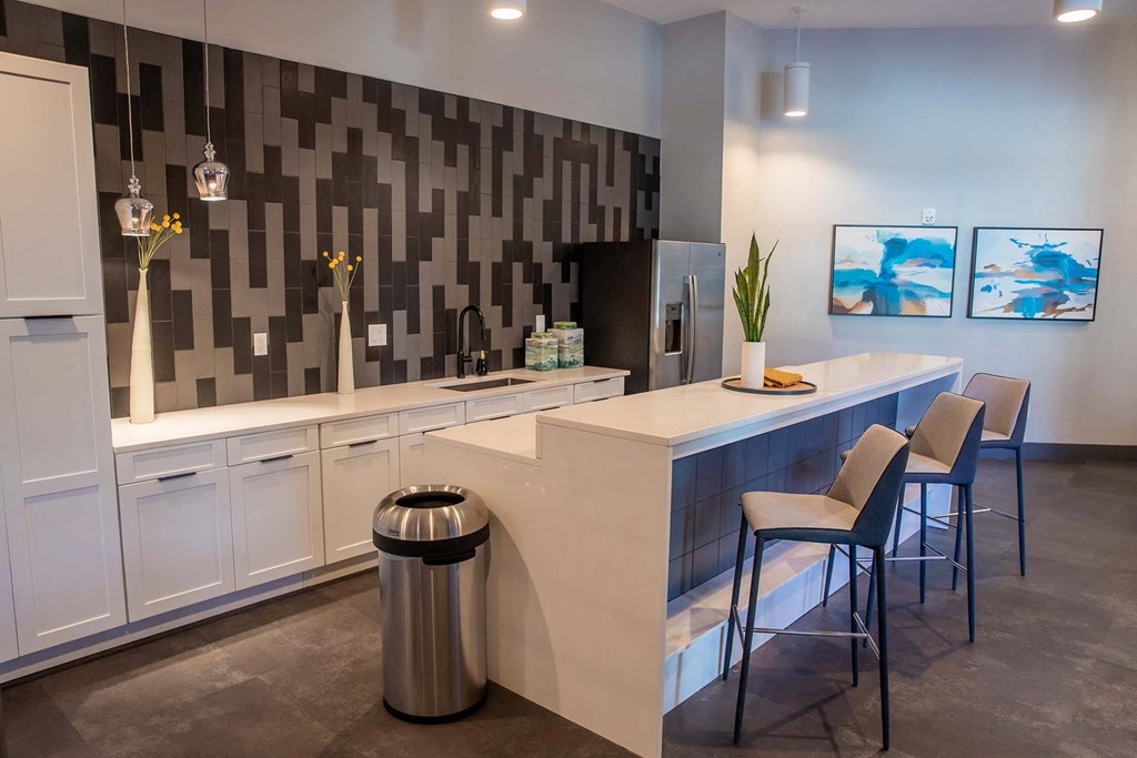 a kitchen with a long counter and stools