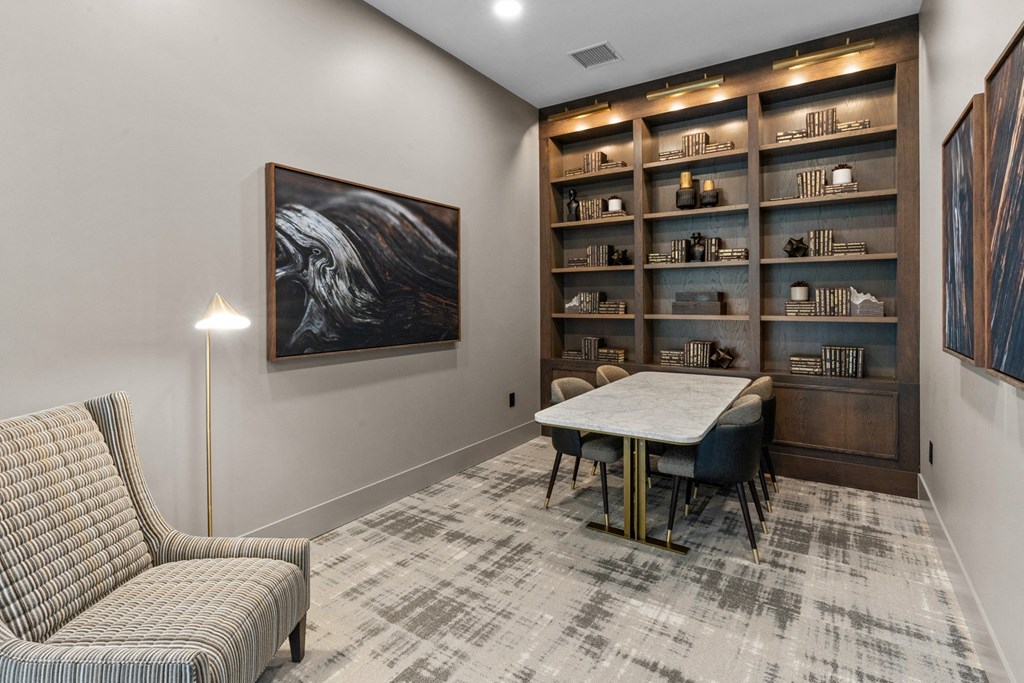 a dining room with a table and chairs and a bookshelf