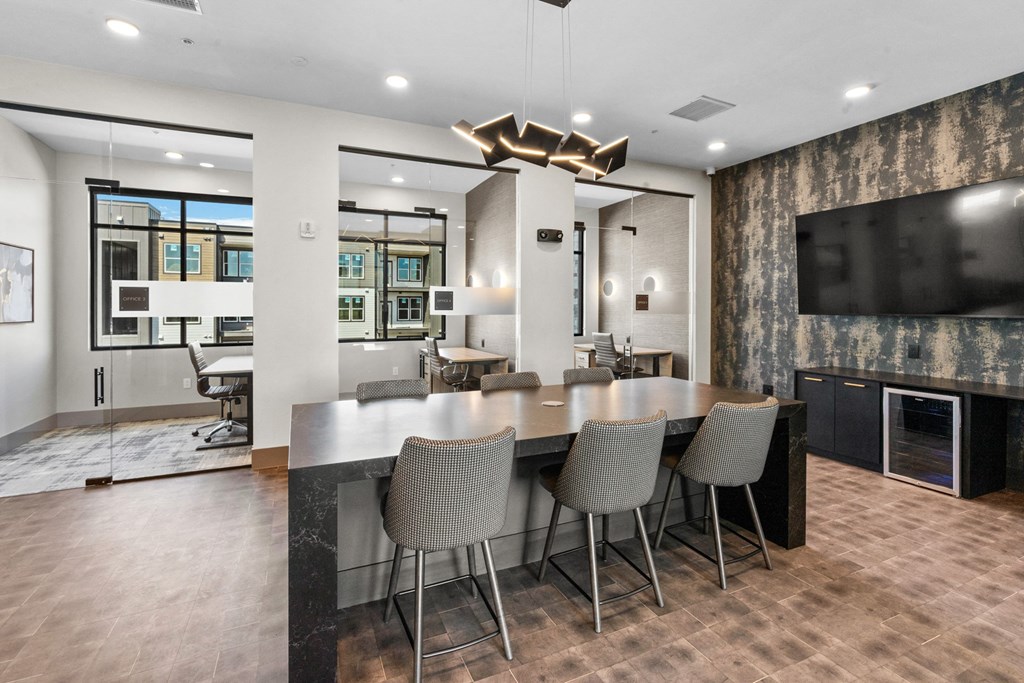 a dining room with a table and chairs in front of a tv