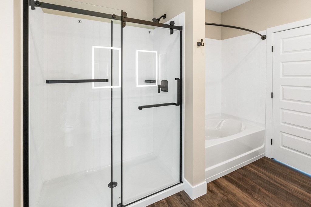 a bathroom with a shower with a glass door
