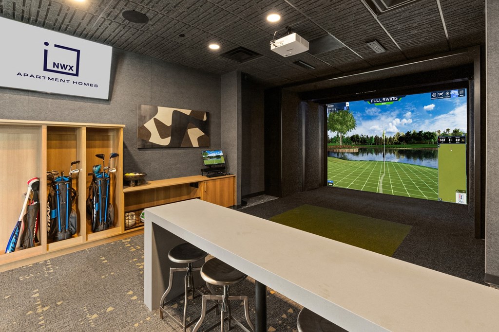 a conference room with a large screen tv and a table with chairs