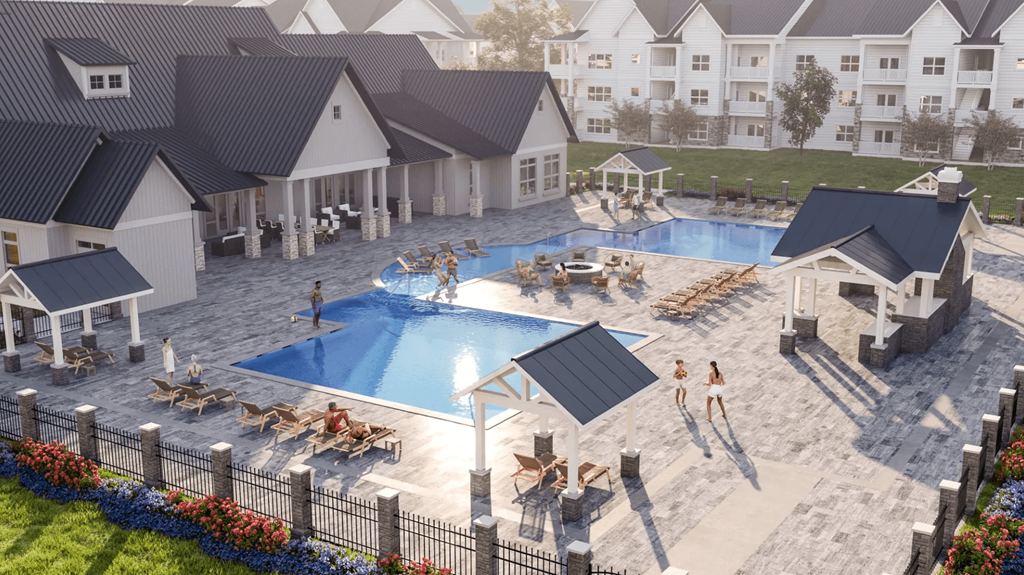 an aerial view of an apartment complex with a pool and people in it