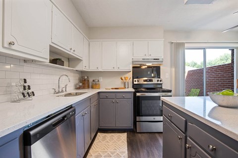 a kitchen with stainless steel appliances and white cabinets