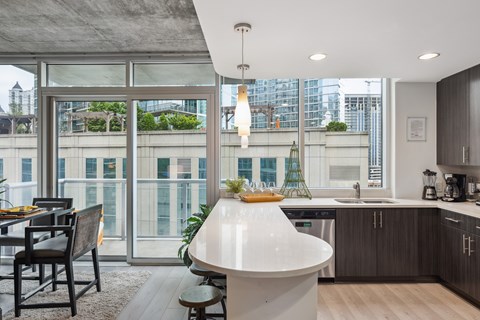 A modern kitchen with a dining table and chairs.