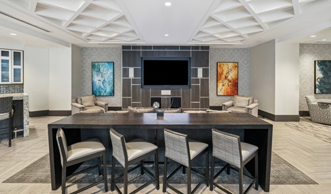 A modern dining room with a large table and chairs.