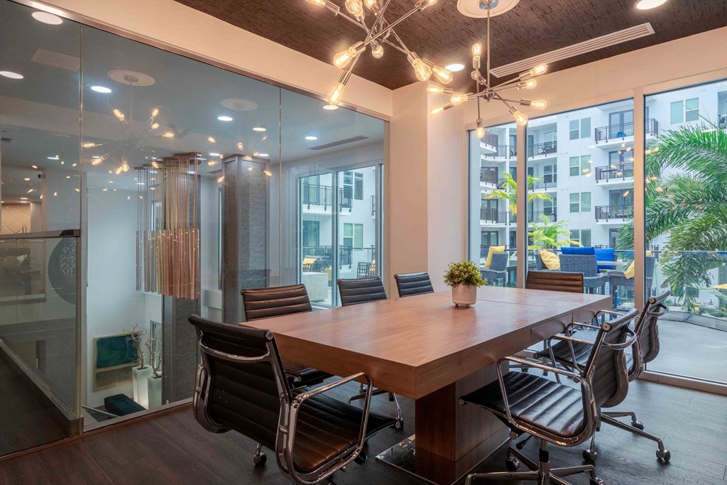 A conference room with a long table and chairs.
