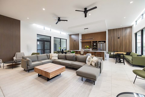 A modern living room with a large grey sofa and a wooden coffee table.