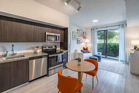 A modern kitchen with a dining table and chairs.