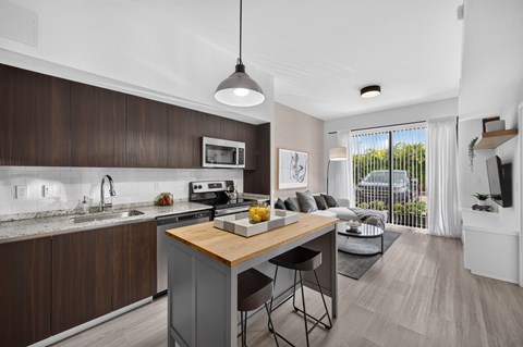 A modern kitchen with dark wood cabinets and a white countertop.