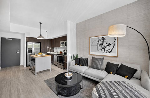 A modern living room with a grey sofa and a coffee table.