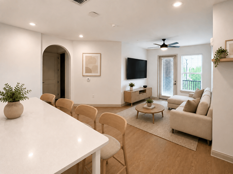 A living room with a white table and chairs.