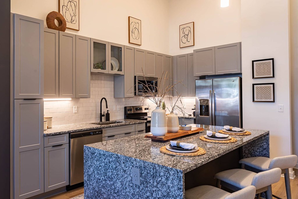 a kitchen with stainless steel appliances and a granite counter top
