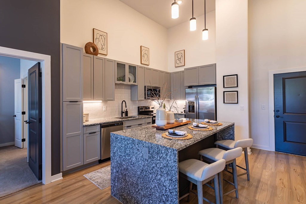 a kitchen with an island and a table with chairs