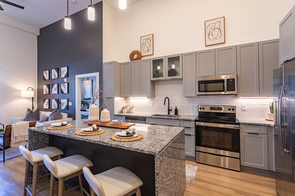 an open kitchen and dining room with stainless steel appliances
