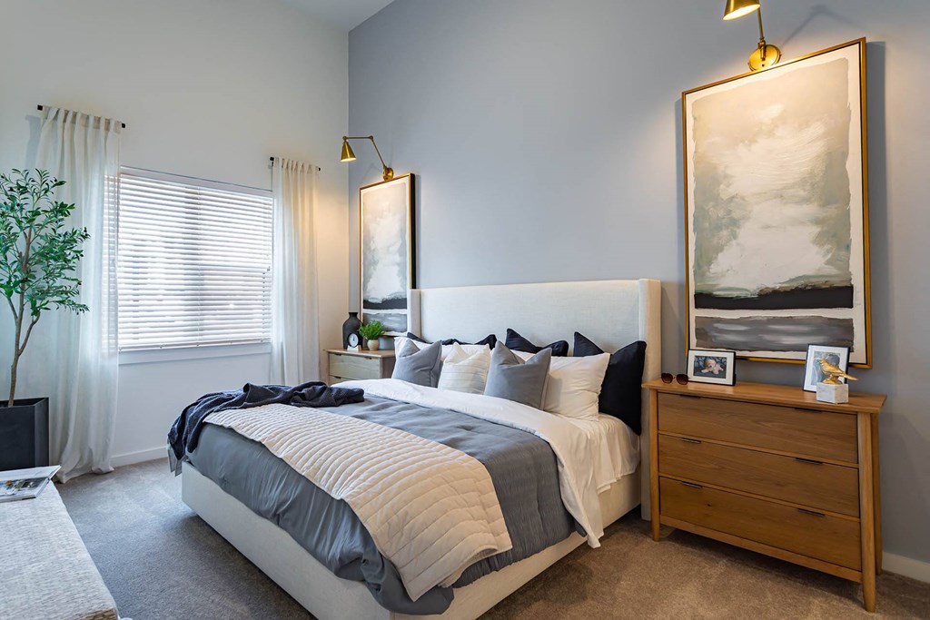 a bedroom with a bed and a dresser