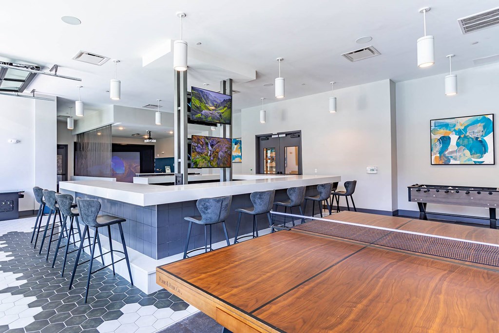 a game room with a pool table and a bar