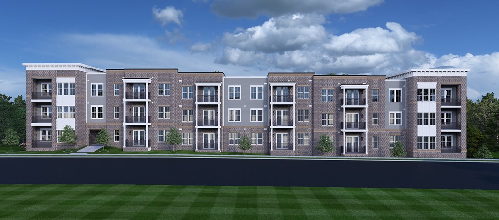 Nashville, TN, Luxury Apartments Near Country Music Hall of Fame and Museum - Crest at Stones Branch - Street View of Property Highlighting Concrete Pathway, Manicured Front Lawn, Private Patios and Balconies, Wooded Area, and Open Grass Field.