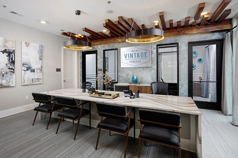 A conference room with a long table and chairs.