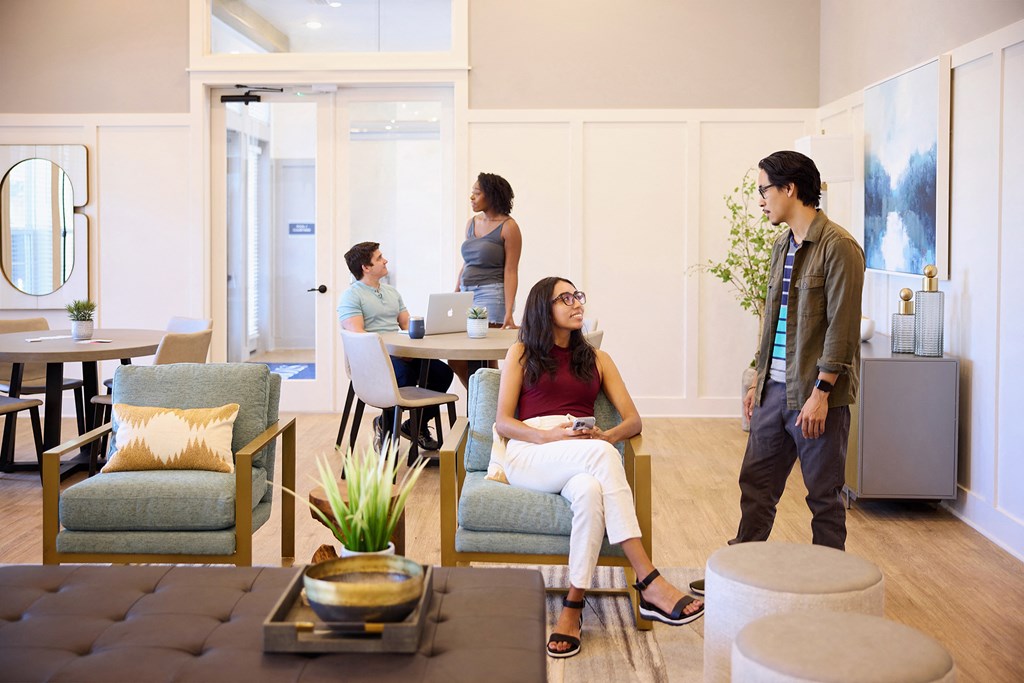 a group of people standing and sitting in a living room