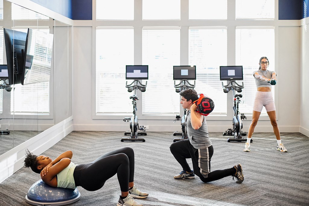a group of people doing exercises in a gym