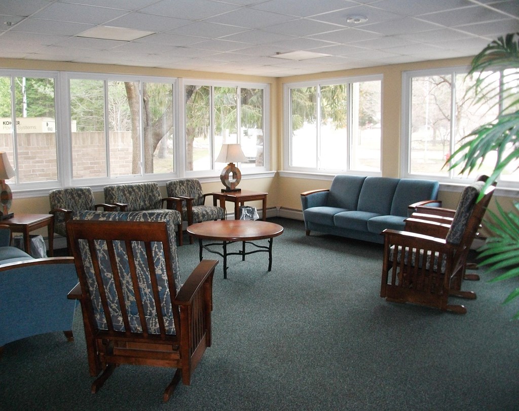 a living room with couches chairs and a table