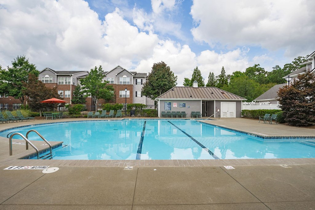 A large swimming pool in front of a building.