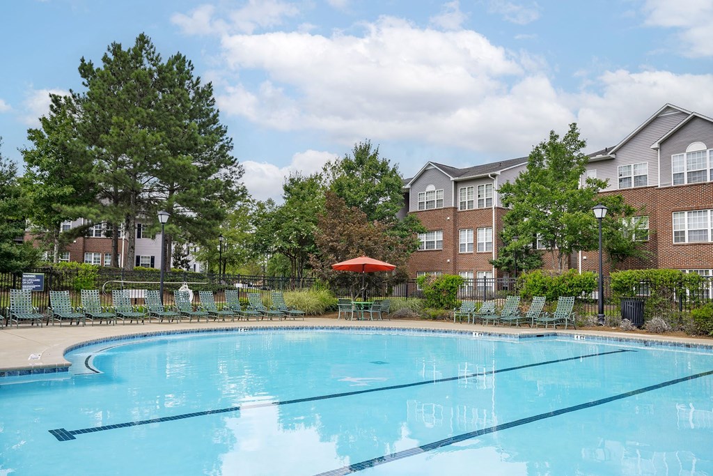 A swimming pool in front of apartment buildings.