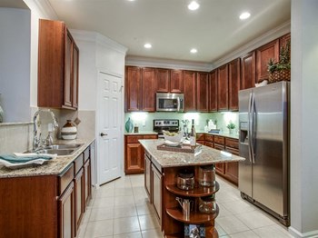 Gourmet Kitchen with Breakfast Bar and Pantry at Orion Prosper Lakes, Texas, 75078