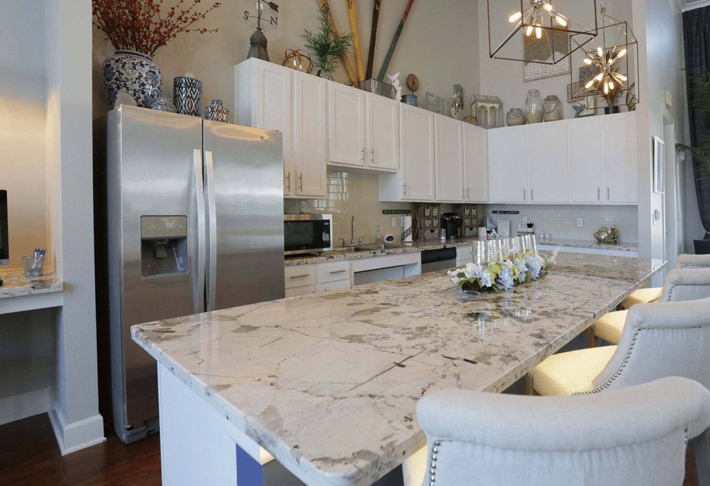 a large kitchen with a marble counter top