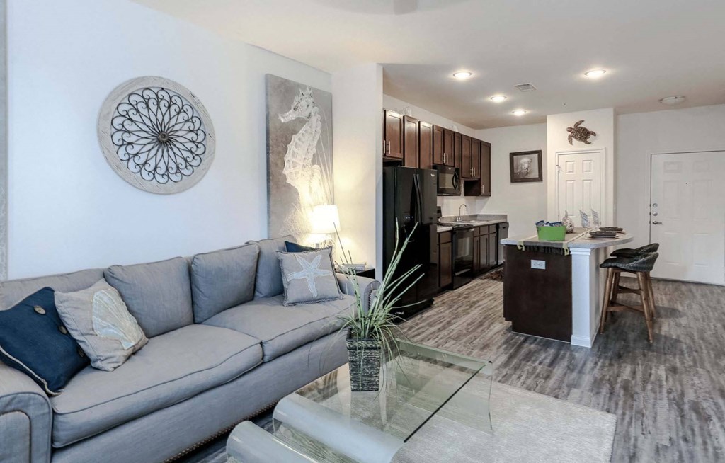a living room with a couch and a glass table