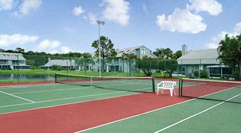 Setting up a game on the on-site tennis court will be an amenity you'll love at Lake in the Woods, Melbourne, FL, 32901 - Photo Gallery 17