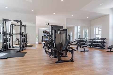 A spacious gym with a variety of equipment including treadmills, weights, and exercise machines.